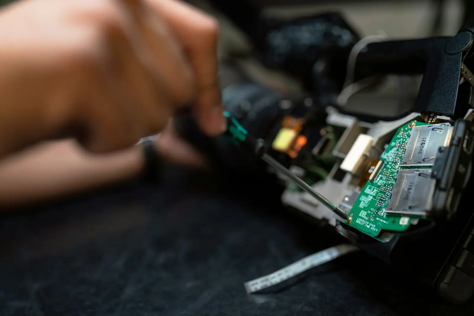 Technician working on electronic components at a service bench