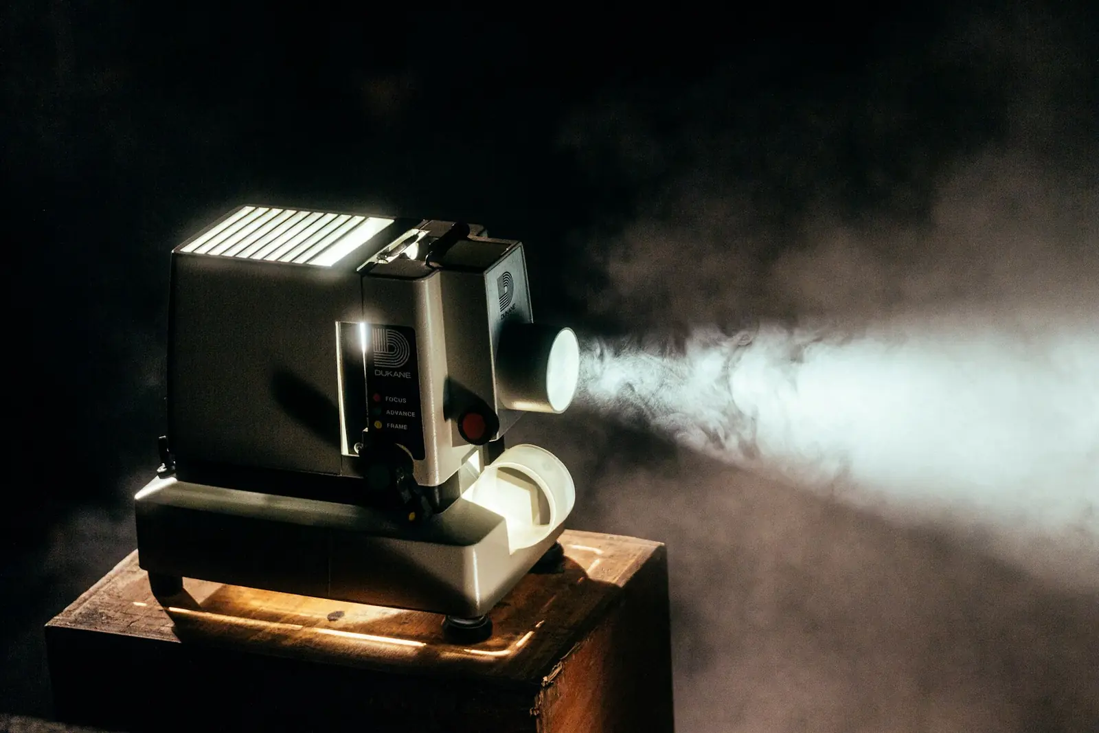 Cinema projector casting a beam of light through haze