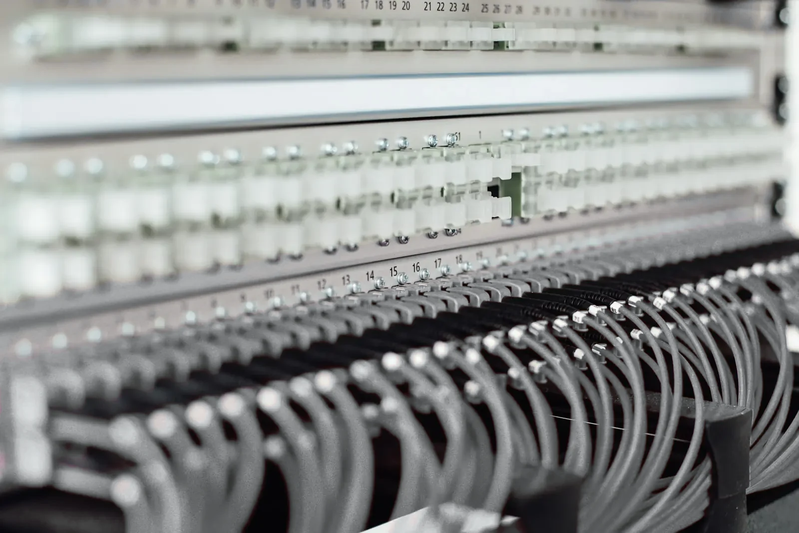 Grey patch leads terminated into a numbered network patch panel