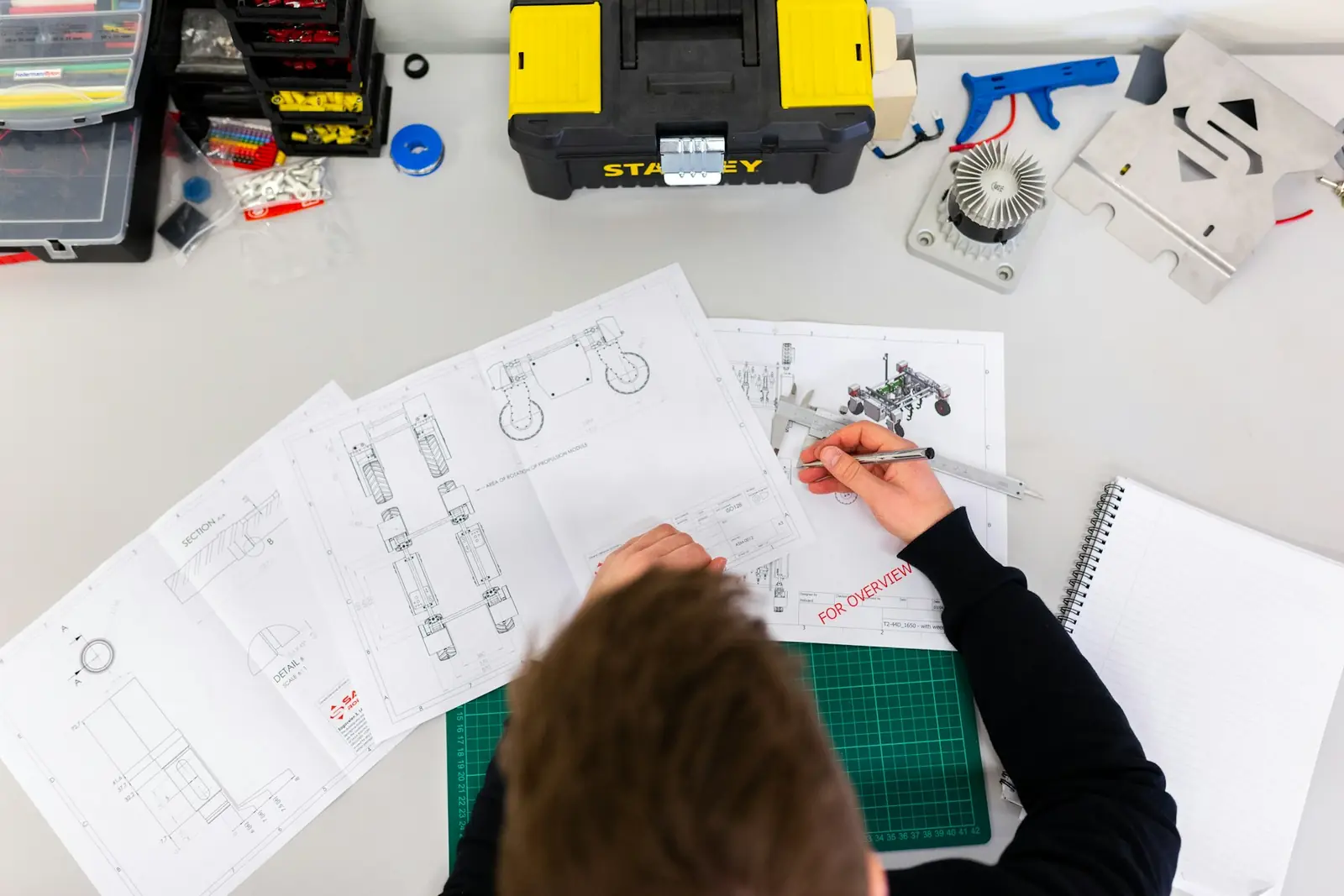 Designer refining visual layouts across technical drawings