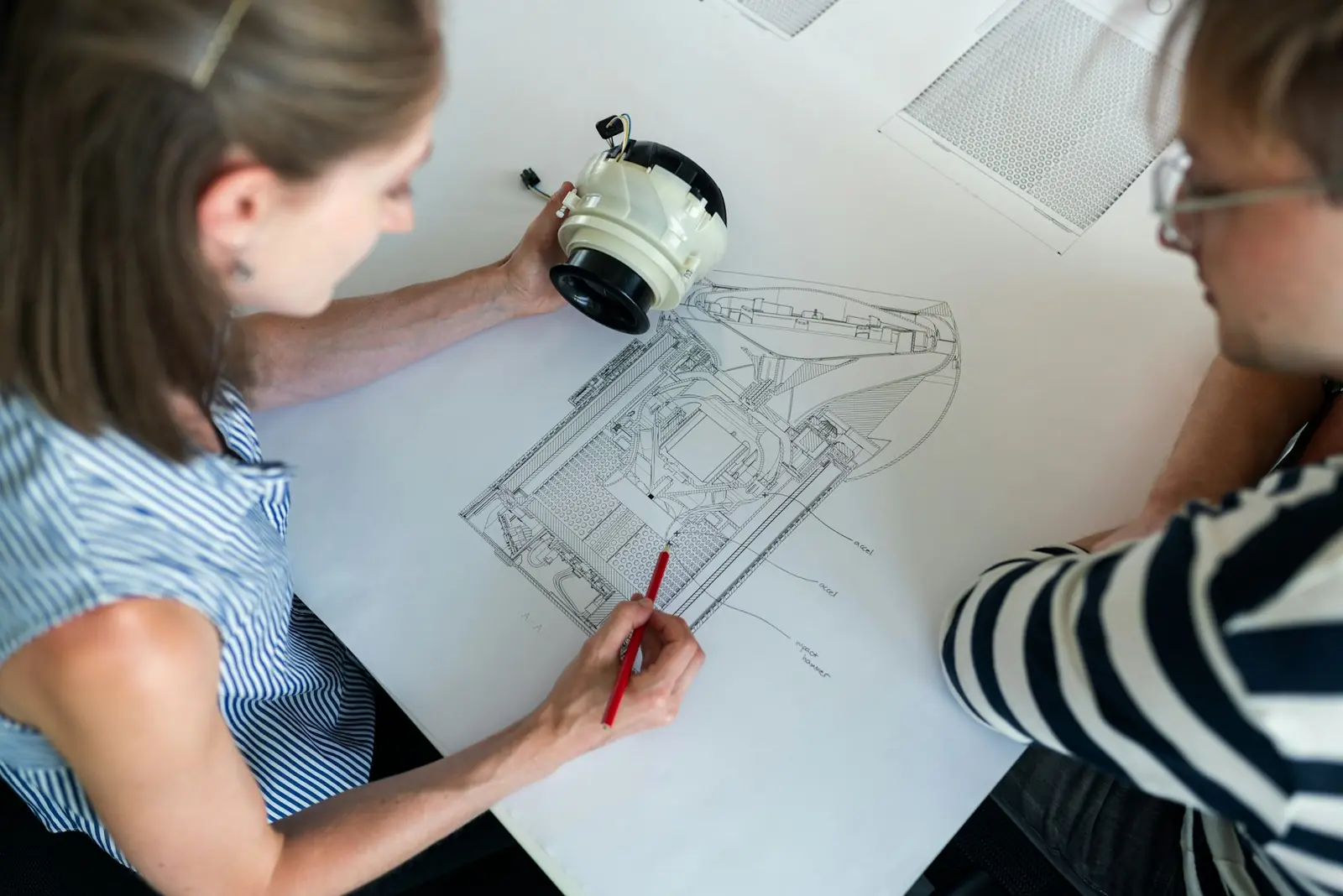 Designers developing brand and campaign visuals at a studio table