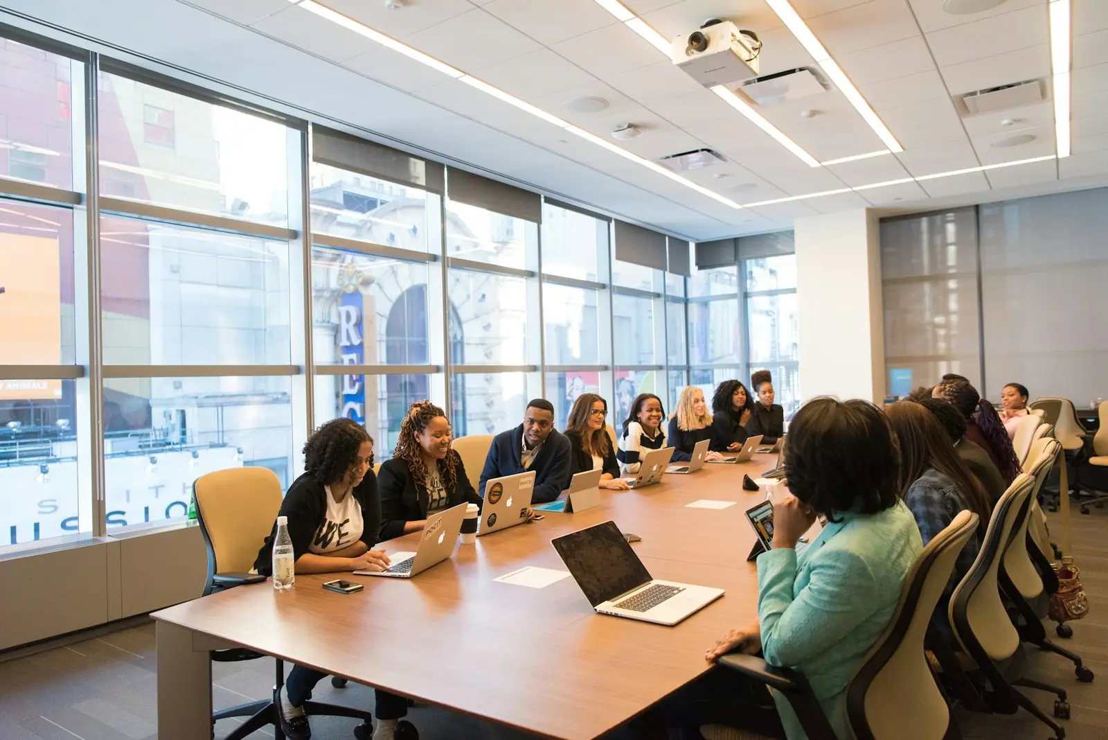 Stakeholders reviewing a portal rollout in a boardroom session