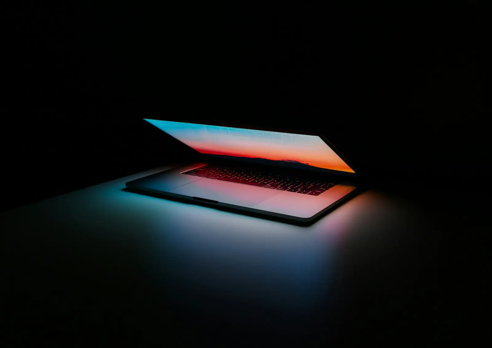 Business laptop illuminated against a dark background representing licensed software