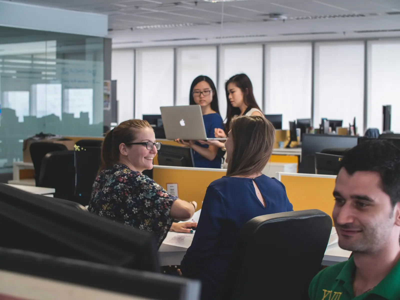 Support team working alongside automated assistance at a shared desk